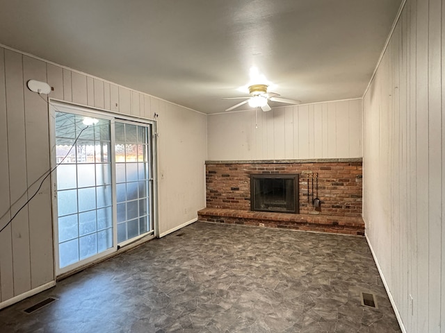 29318 Orvylle Dr, Warren, MI 48092 - unfurnished living room with wooden walls, a ceiling fan, visible vents, and a fireplace
