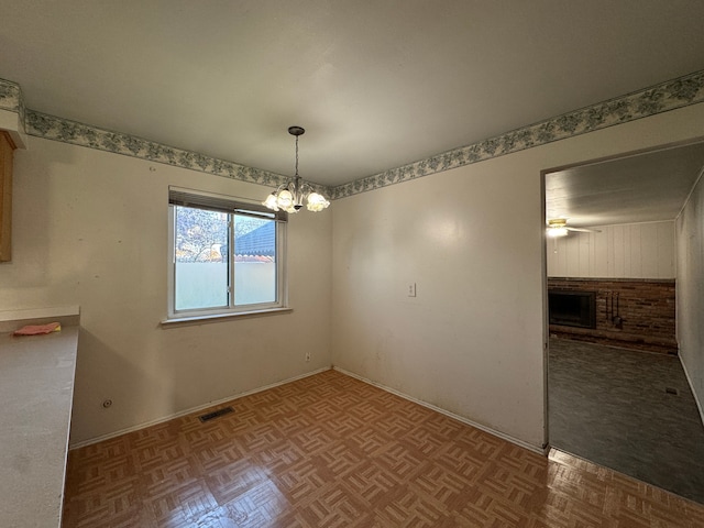 29318 Orvylle Dr, Warren, MI 48092 - unfurnished dining area featuring a notable chandelier, a brick fireplace, and visible vents