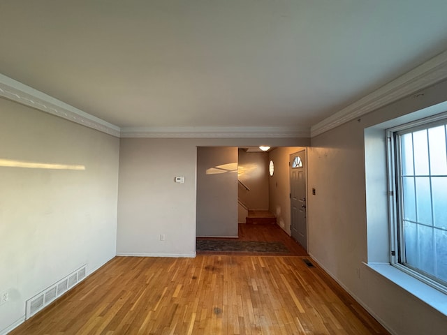 29318 Orvylle Dr, Warren, MI 48092 - unfurnished room featuring visible vents, crown molding, wood finished floors, and stairway
