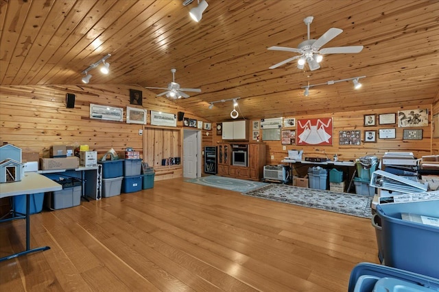 2745 Lari Ct, West Bloomfield, MI 48324 - living room with a ceiling fan, vaulted ceiling, wooden walls, and track lighting