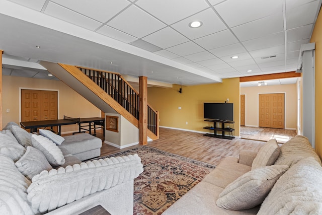 9025 Huron Bluffs Dr, White Lake, MI 48386 - living room featuring stairs, wood finished floors, recessed lighting, a paneled ceiling, and baseboards