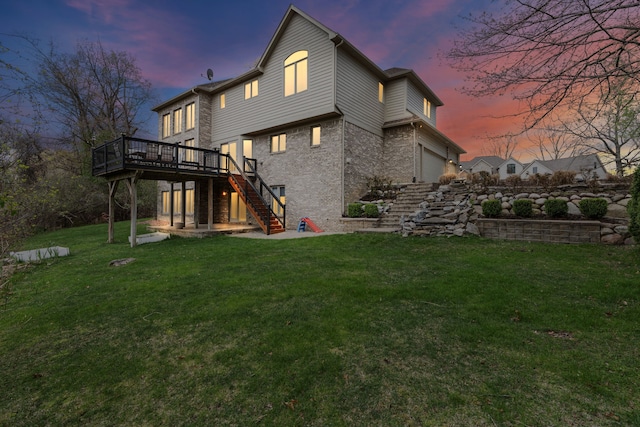 9025 Huron Bluffs Dr, White Lake, MI 48386 - back of property at dusk featuring stairs, a wooden deck, brick siding, and a lawn