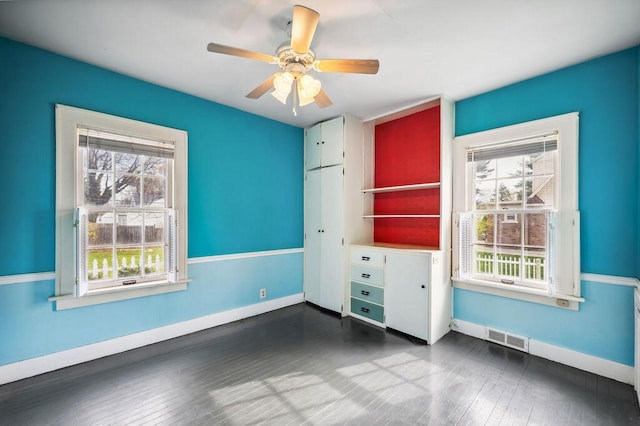 interior space featuring visible vents, baseboards, plenty of natural light, and ceiling fan