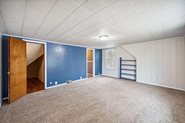 bonus room featuring visible vents, baseboards, and carpet flooring