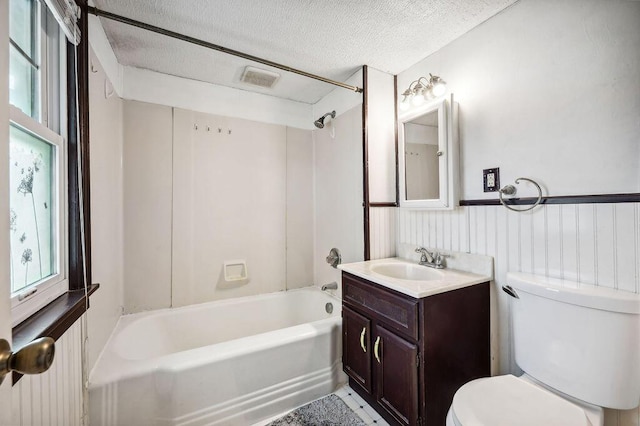 full bathroom with vanity, shower / bath combination, a textured ceiling, toilet, and visible vents