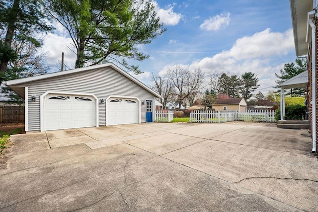 detached garage featuring fence