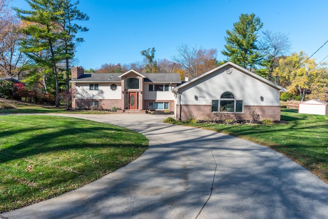 29632 Pond Ridge Rd, Farmington Hills, MI 48334 - raised ranch featuring concrete driveway, a front lawn, and brick siding