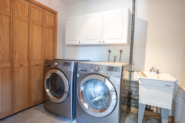 29632 Pond Ridge Rd, Farmington Hills, MI 48334 - clothes washing area featuring light tile patterned floors, a sink, cabinet space, and washer and clothes dryer