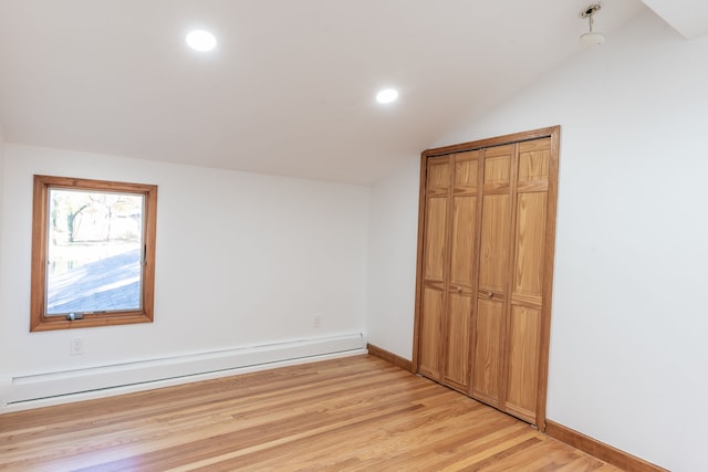 29632 Pond Ridge Rd, Farmington Hills, MI 48334 - unfurnished bedroom with baseboard heating, light wood-style floors, baseboards, and vaulted ceiling
