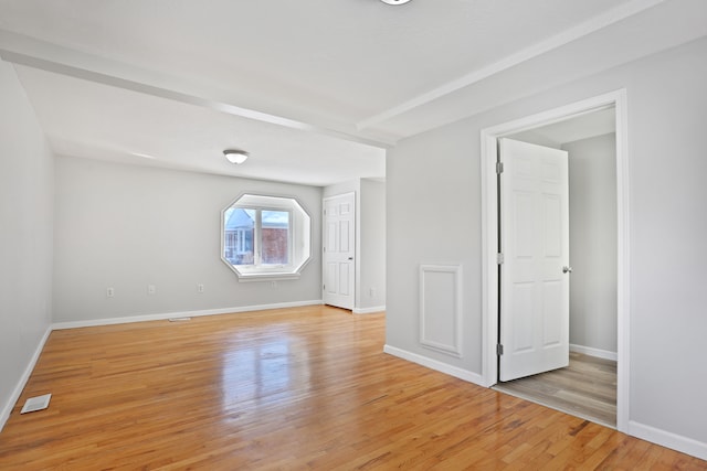 25763 Gibraltar Rd, Flat Rock, MI 48134 - empty room with baseboards, light wood finished floors, and visible vents