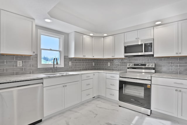 25763 Gibraltar Rd, Flat Rock, MI 48134 - kitchen featuring marble finish floor, recessed lighting, white cabinetry, a sink, and stainless steel appliances