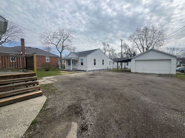 25763 Gibraltar Rd, Flat Rock, MI 48134 - exterior space with a detached garage and an outbuilding