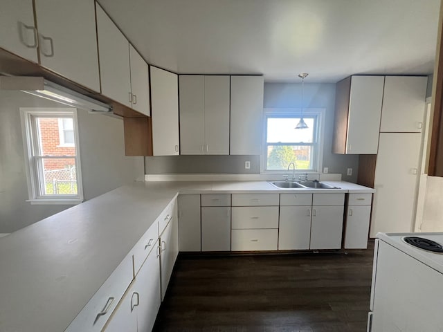 25763 Gibraltar Rd, Flat Rock, MI 48134 - kitchen featuring light countertops, dark wood-style flooring, white electric range oven, and a sink