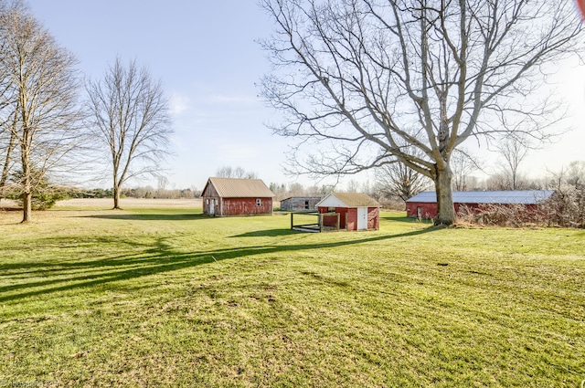 view of yard featuring an outdoor structure and an outbuilding