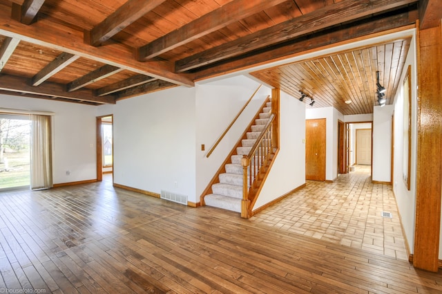 interior space featuring visible vents, baseboards, stairs, and wooden ceiling