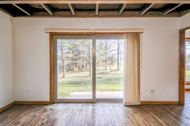 doorway to outside with baseboards and hardwood / wood-style floors