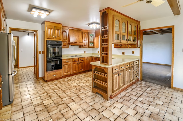 kitchen featuring open shelves, light countertops, freestanding refrigerator, dobule oven black, and white electric stovetop