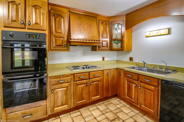 kitchen with brown cabinetry, black appliances, a sink, and light countertops