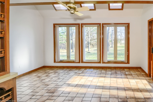 spare room with baseboards, a ceiling fan, and vaulted ceiling