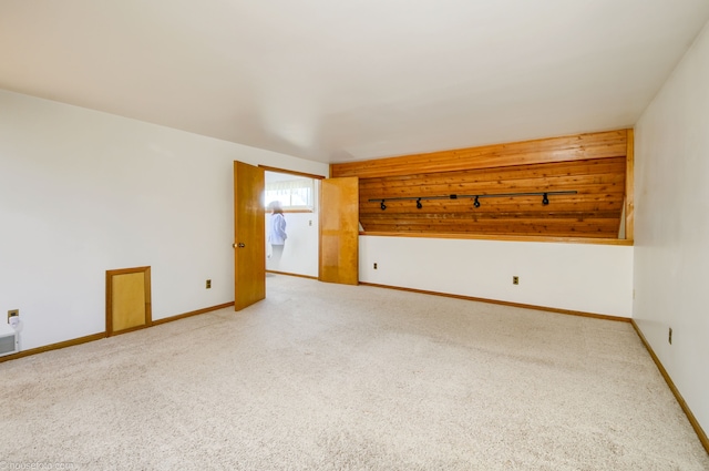 unfurnished room with light carpet and baseboards