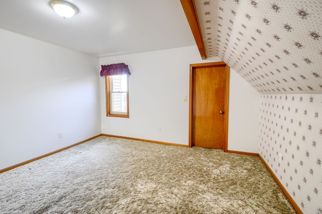 bonus room featuring vaulted ceiling with beams, baseboards, and carpet