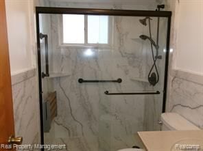 24306 Valley Ave, Eastpointe, MI 48021 - bathroom with toilet, vanity, a marble finish shower, and tile walls