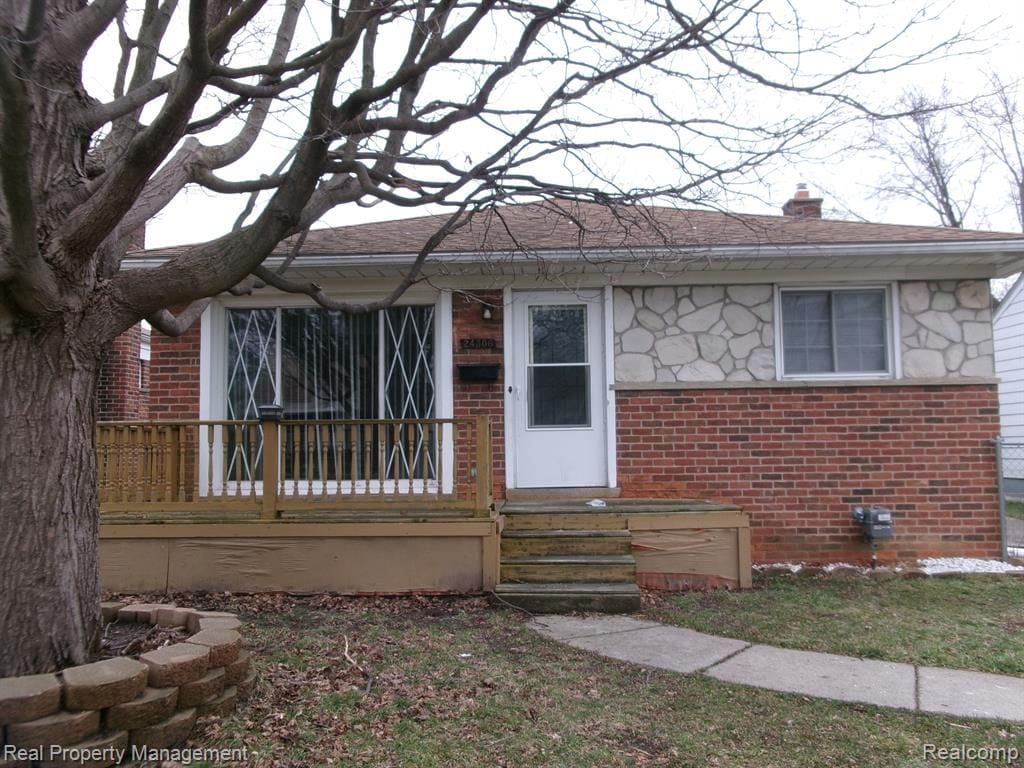 24306 Valley Ave, Eastpointe, MI 48021 - view of front of property featuring brick siding, roof with shingles, stone siding, and a chimney