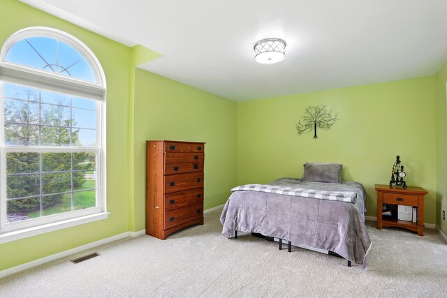 carpeted bedroom featuring baseboards