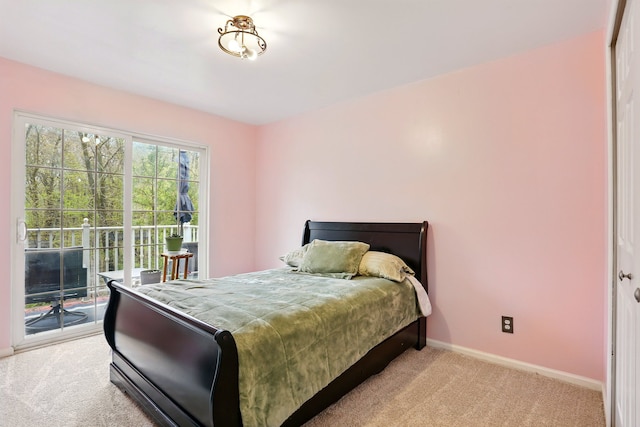 bedroom with light colored carpet, access to outside, and baseboards