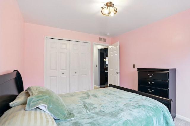 bedroom featuring baseboards, a closet, and carpet floors