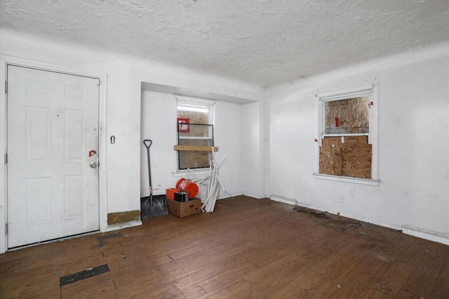 entryway with a textured ceiling and hardwood / wood-style floors