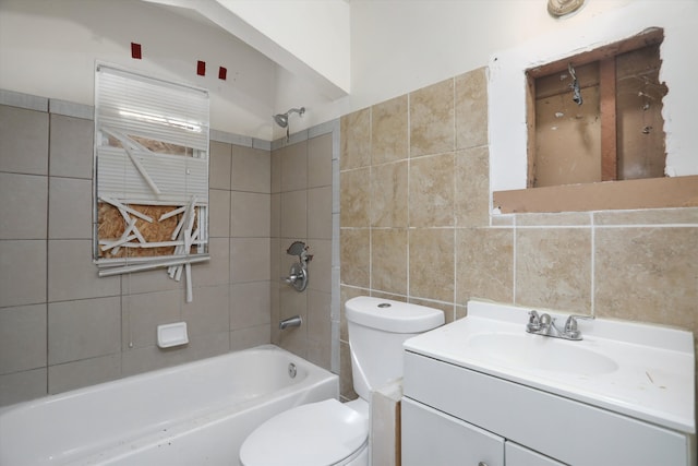 bathroom featuring tile walls, toilet, bathtub / shower combination, and vanity