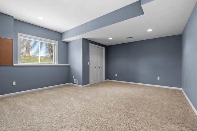carpeted empty room featuring visible vents, baseboards, and recessed lighting