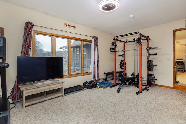 workout room with baseboards and carpet