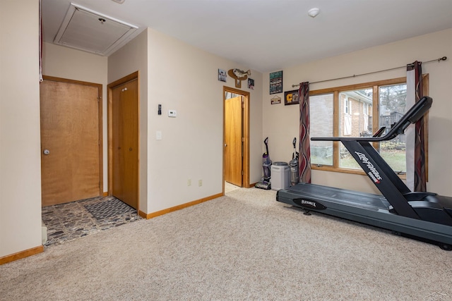 workout area with carpet floors, baseboards, and attic access