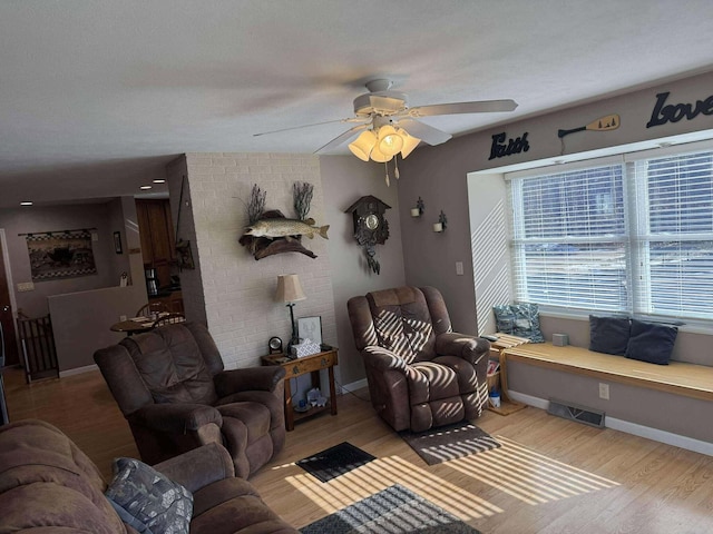 18175 Lake Dr, Big Rapids, MI 49307 - living area featuring visible vents, baseboards, wood finished floors, and ceiling fan
