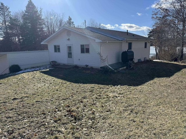 18175 Lake Dr, Big Rapids, MI 49307 - rear view of property with heating fuel and a lawn