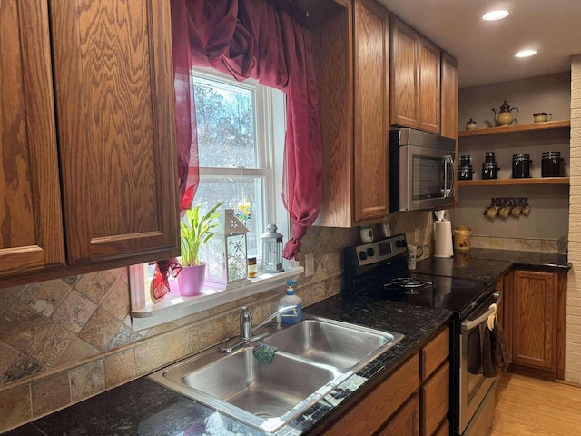 18175 Lake Dr, Big Rapids, MI 49307 - kitchen featuring a sink, backsplash, open shelves, and stainless steel appliances