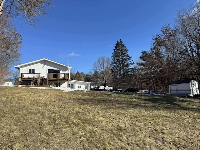 18175 Lake Dr, Big Rapids, MI 49307 - view of yard with a storage shed, a wooden deck, and an outdoor structure