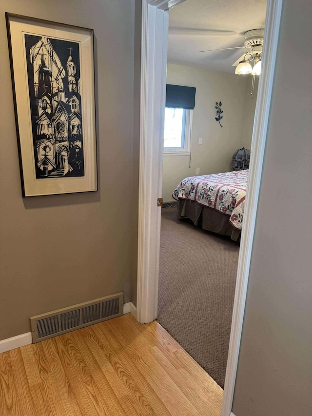 18175 Lake Dr, Big Rapids, MI 49307 - bedroom featuring wood finished floors, baseboards, a ceiling fan, and visible vents