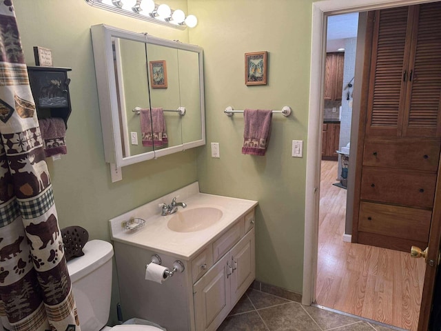 18175 Lake Dr, Big Rapids, MI 49307 - full bath with tile patterned flooring, toilet, and vanity
