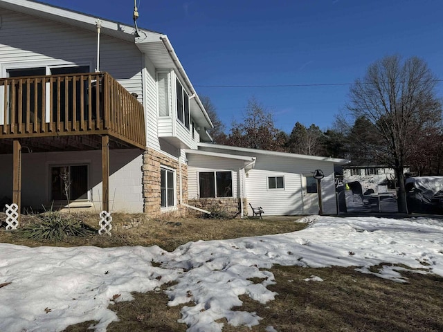 18175 Lake Dr, Big Rapids, MI 49307 - view of snow covered exterior with a wooden deck