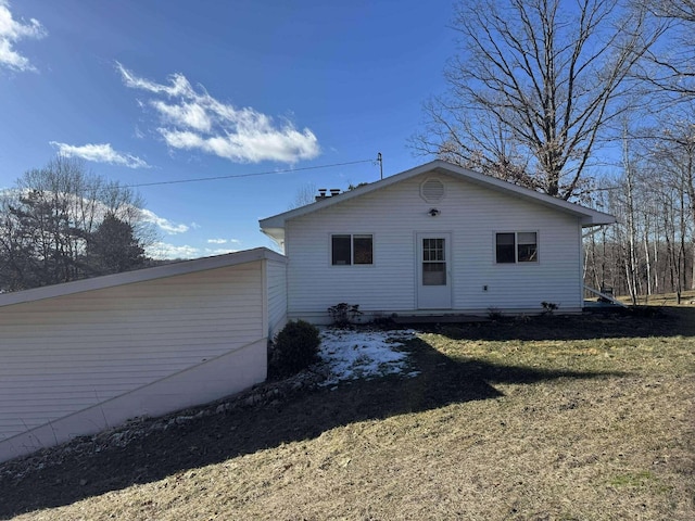 18175 Lake Dr, Big Rapids, MI 49307 - view of property exterior featuring a lawn