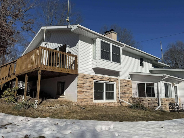 18175 Lake Dr, Big Rapids, MI 49307 - rear view of property with stone siding, a deck, and a chimney