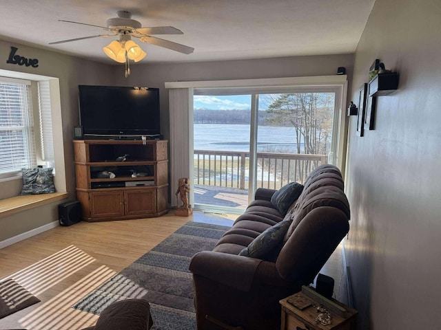 18175 Lake Dr, Big Rapids, MI 49307 - living room featuring ceiling fan, light wood-style floors, and baseboards