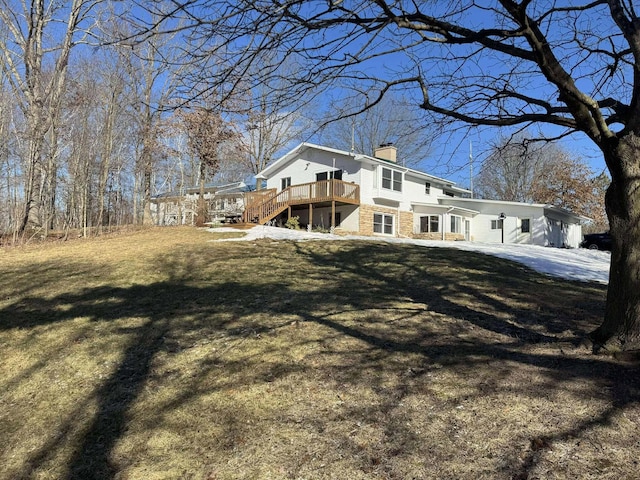 18175 Lake Dr, Big Rapids, MI 49307 - rear view of house with a yard, a wooden deck, and a chimney