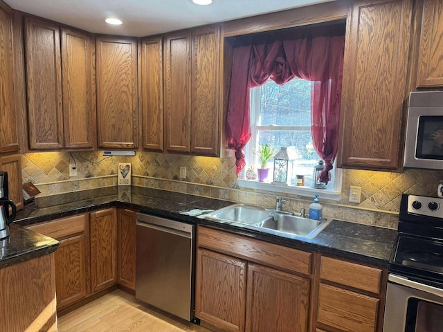 18175 Lake Dr, Big Rapids, MI 49307 - kitchen featuring a sink, backsplash, light wood-type flooring, and stainless steel appliances