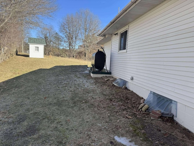 18175 Lake Dr, Big Rapids, MI 49307 - view of yard featuring a storage shed, heating fuel, and an outbuilding