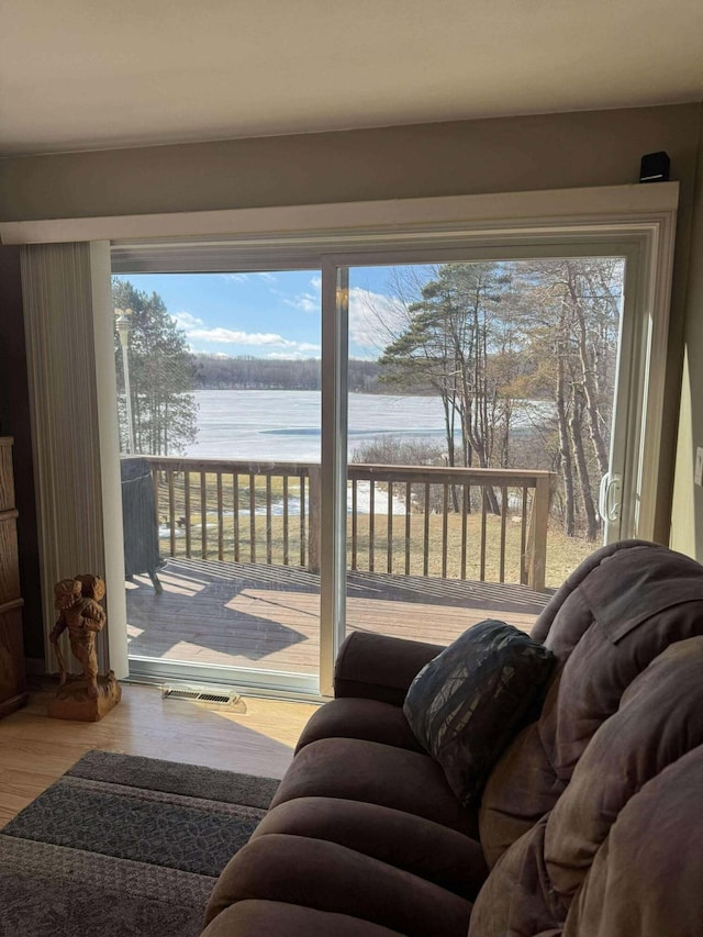 18175 Lake Dr, Big Rapids, MI 49307 - doorway to outside with a water view and wood finished floors