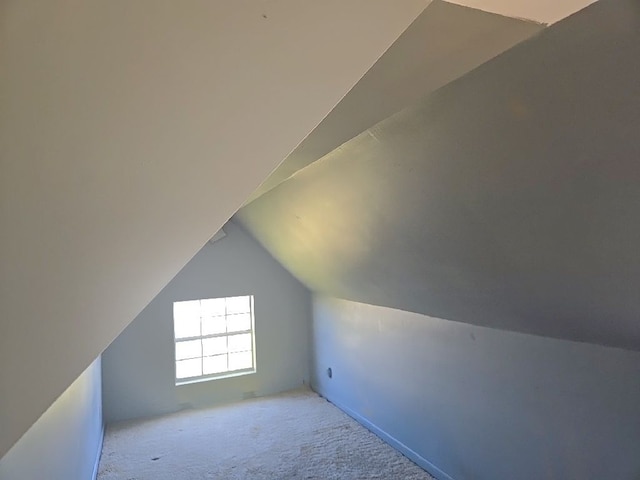 additional living space with lofted ceiling and carpet flooring